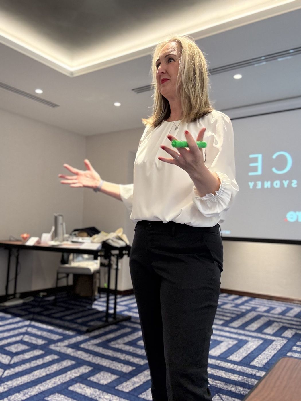 Gabby facilitating a leadership team session, mid-explanation